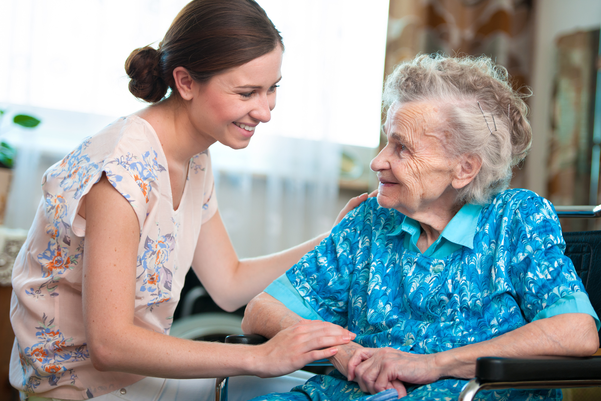A caregiver sharing a warm moment with an older adult
